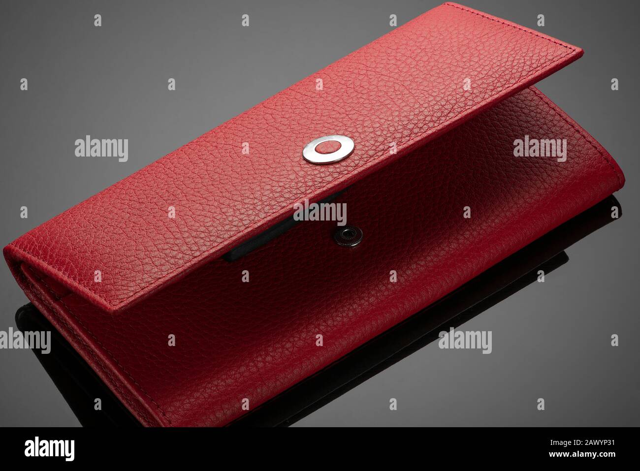 Fashionable red leather women's wallet on a dark background Stock Photo