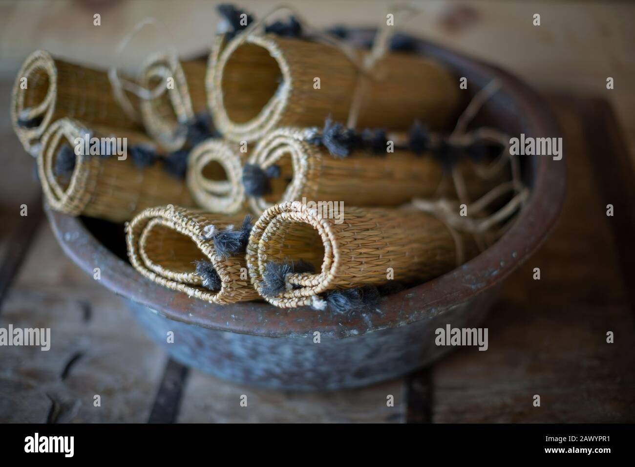 Rolled up rustic straw placemats in bowl Stock Photo Alamy