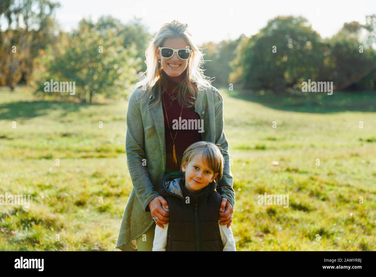 Portrait happy mother and son in sunny park Stock Photo