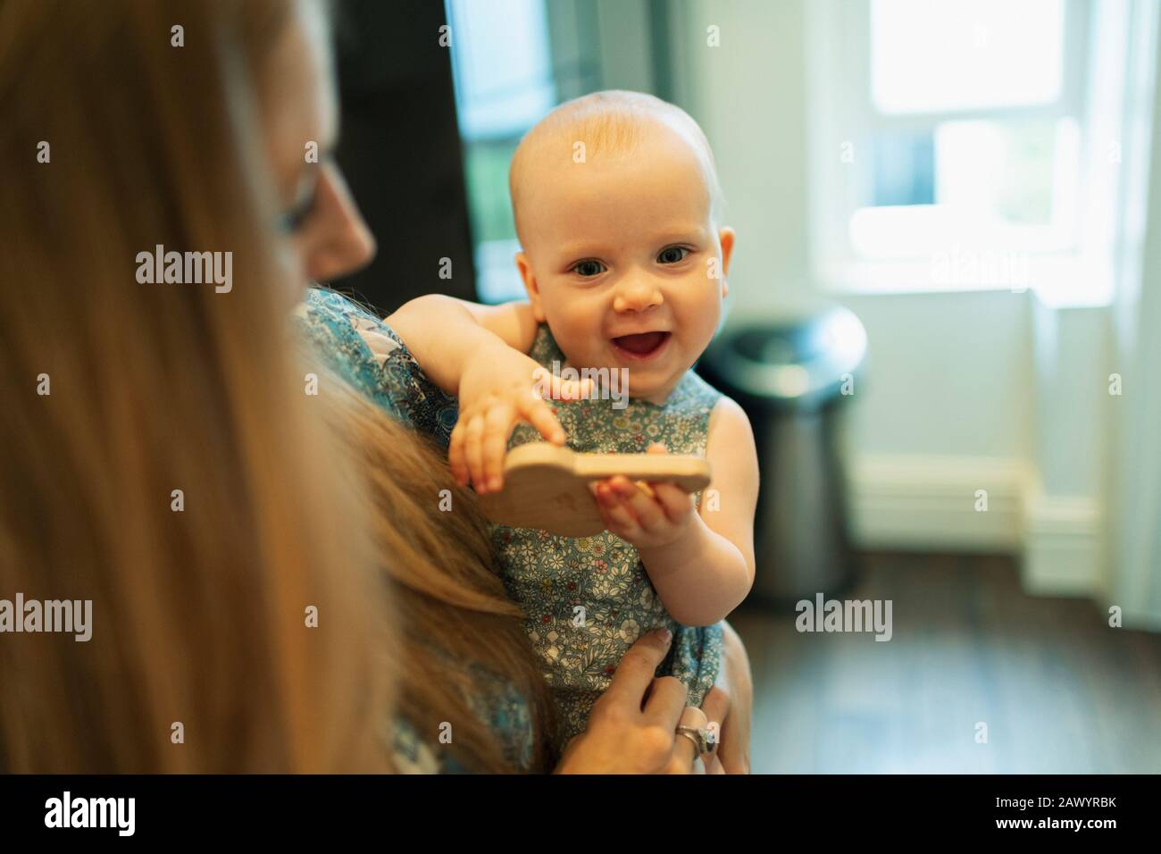 Portrait cute baby girl in mother arms Stock Photo