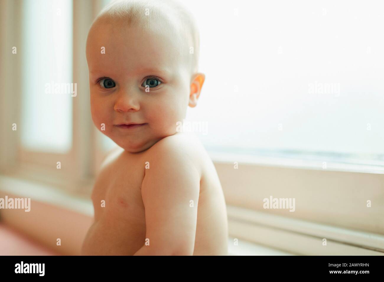 Portrait cute baby girl in window Stock Photo