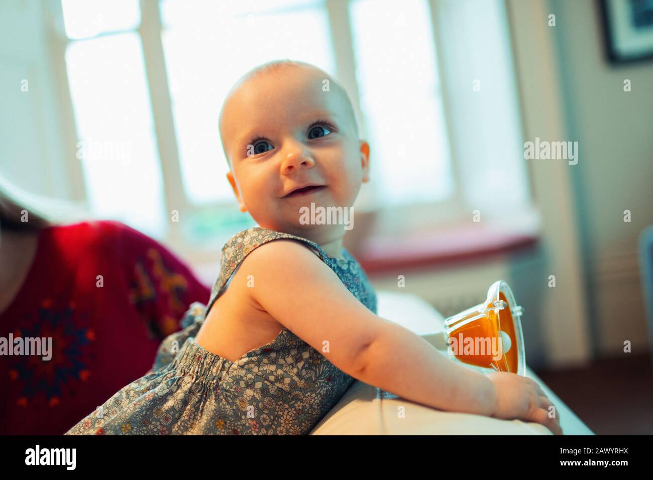 Cute baby girl looking over shoulder Stock Photo