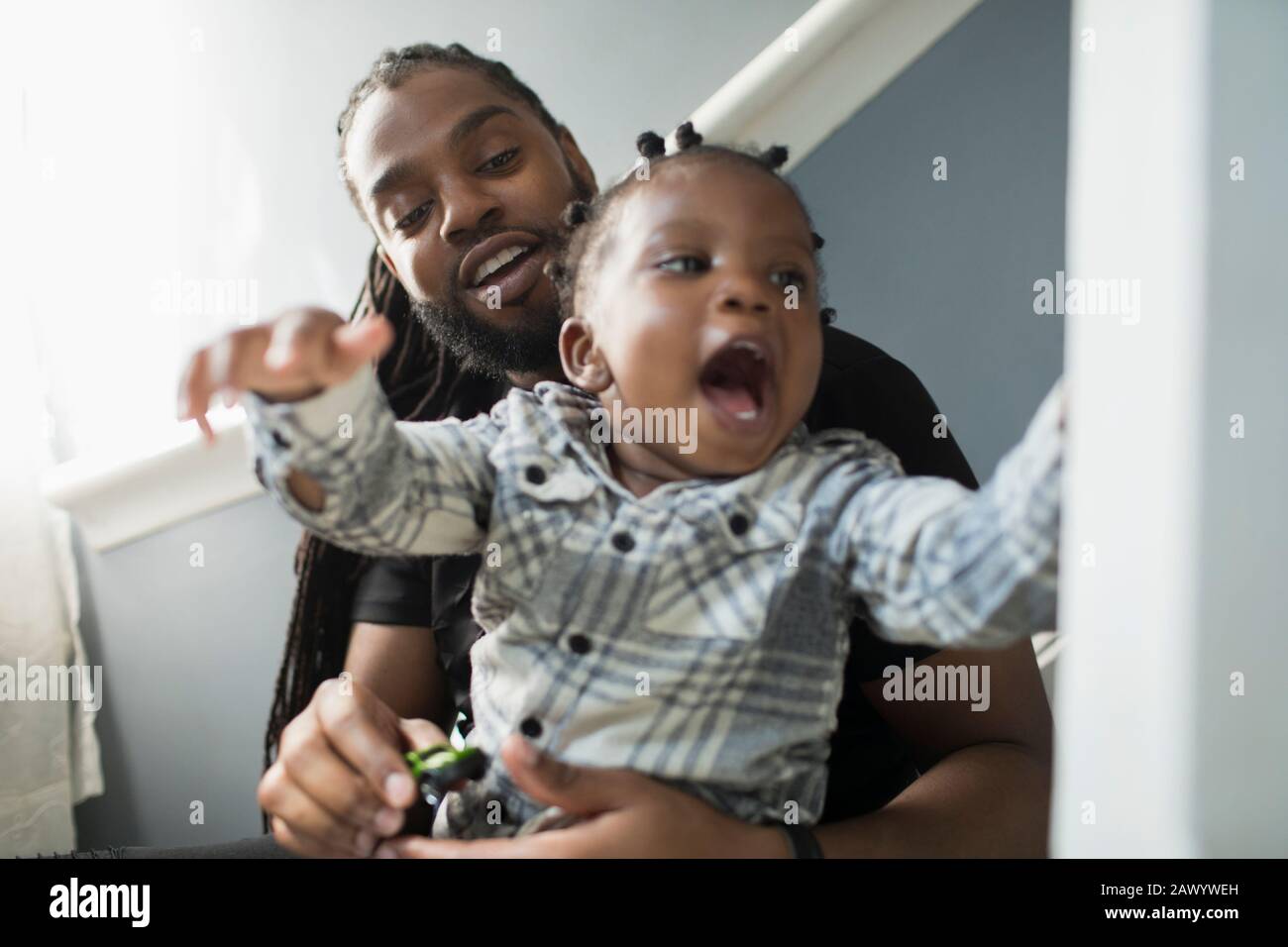 Father and toddler son playing Stock Photo