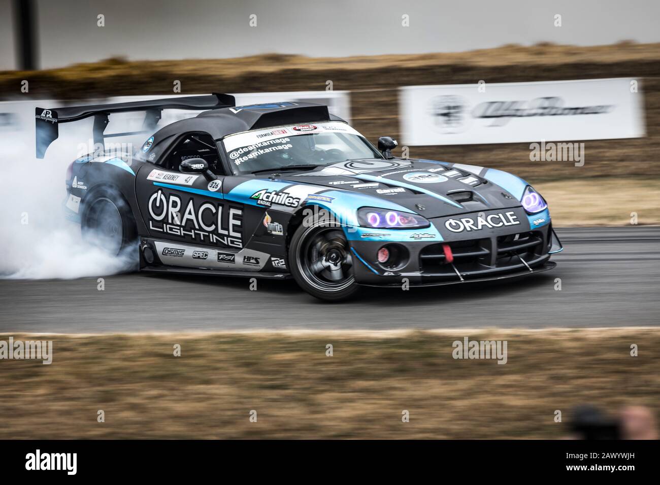 Dean Kearney drifting a 2016 Dodge Viper to produce copious rear tyre smoke at the 2018 Goodwood Festival of Speed. Stock Photo