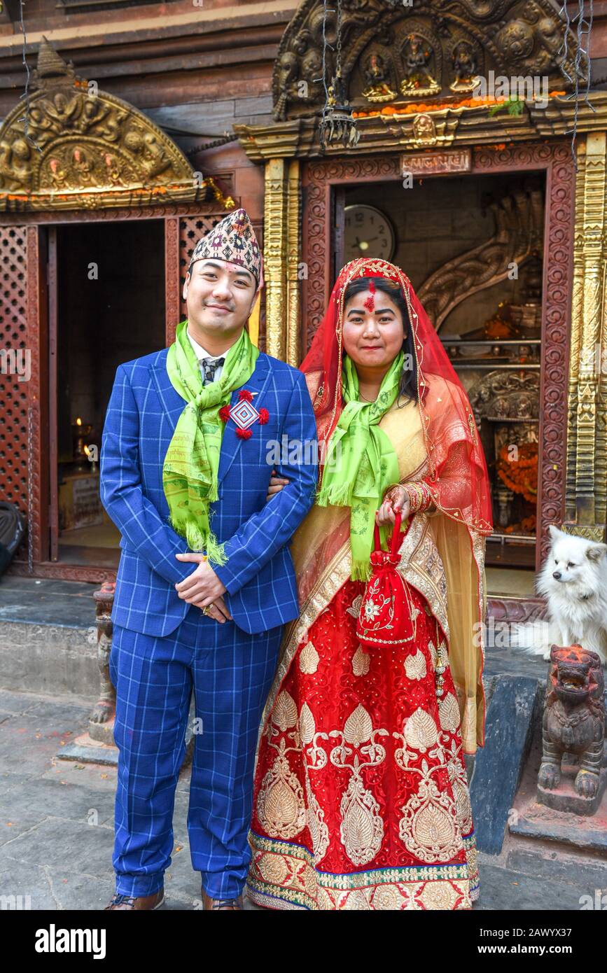 Patan, Nepal - 24 January 2020: wedding couple on traditional clothes at a temple of Patan near Kathmandu in Nepal Stock Photo