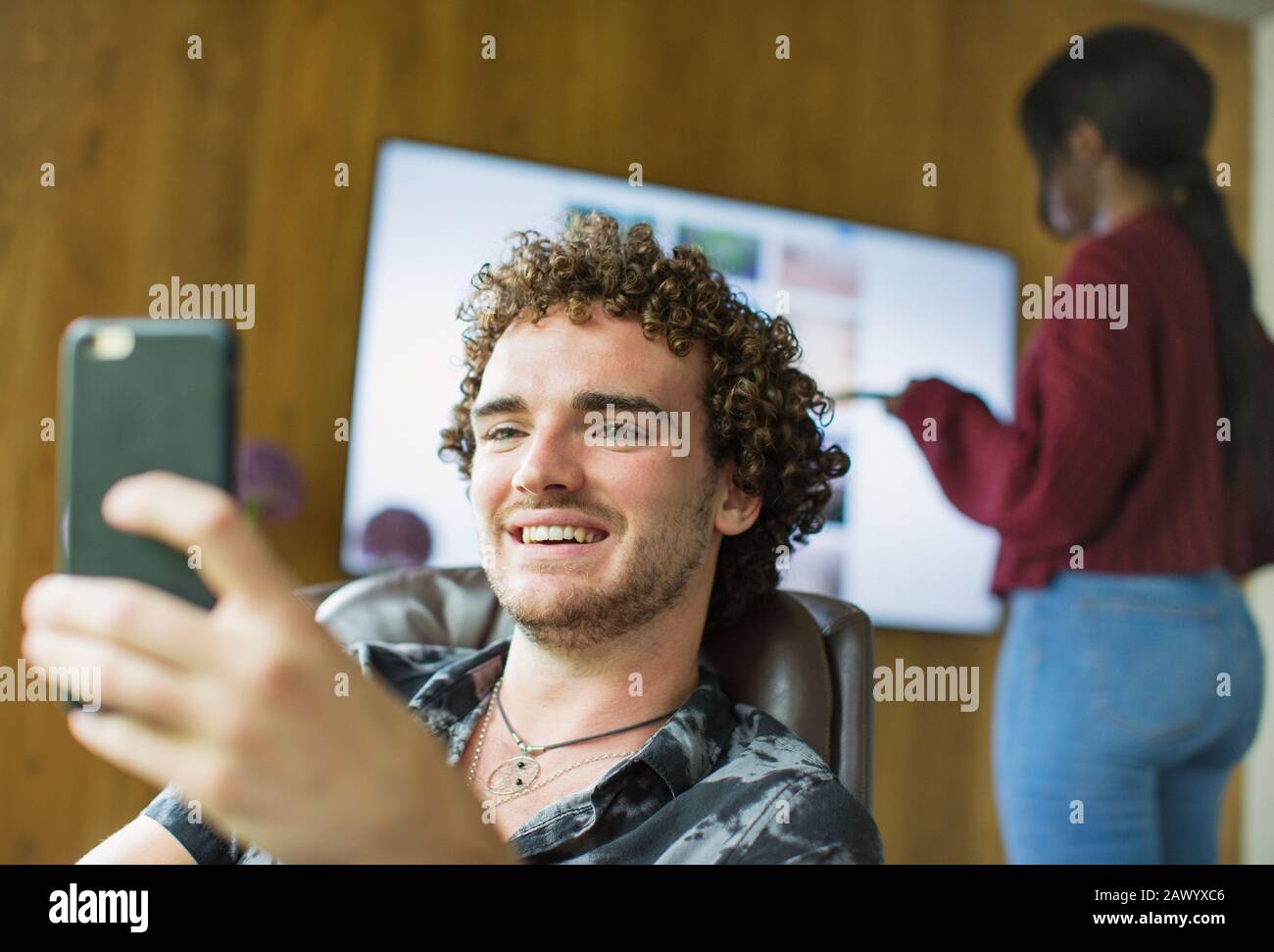 Happy young man using smart phone Stock Photo