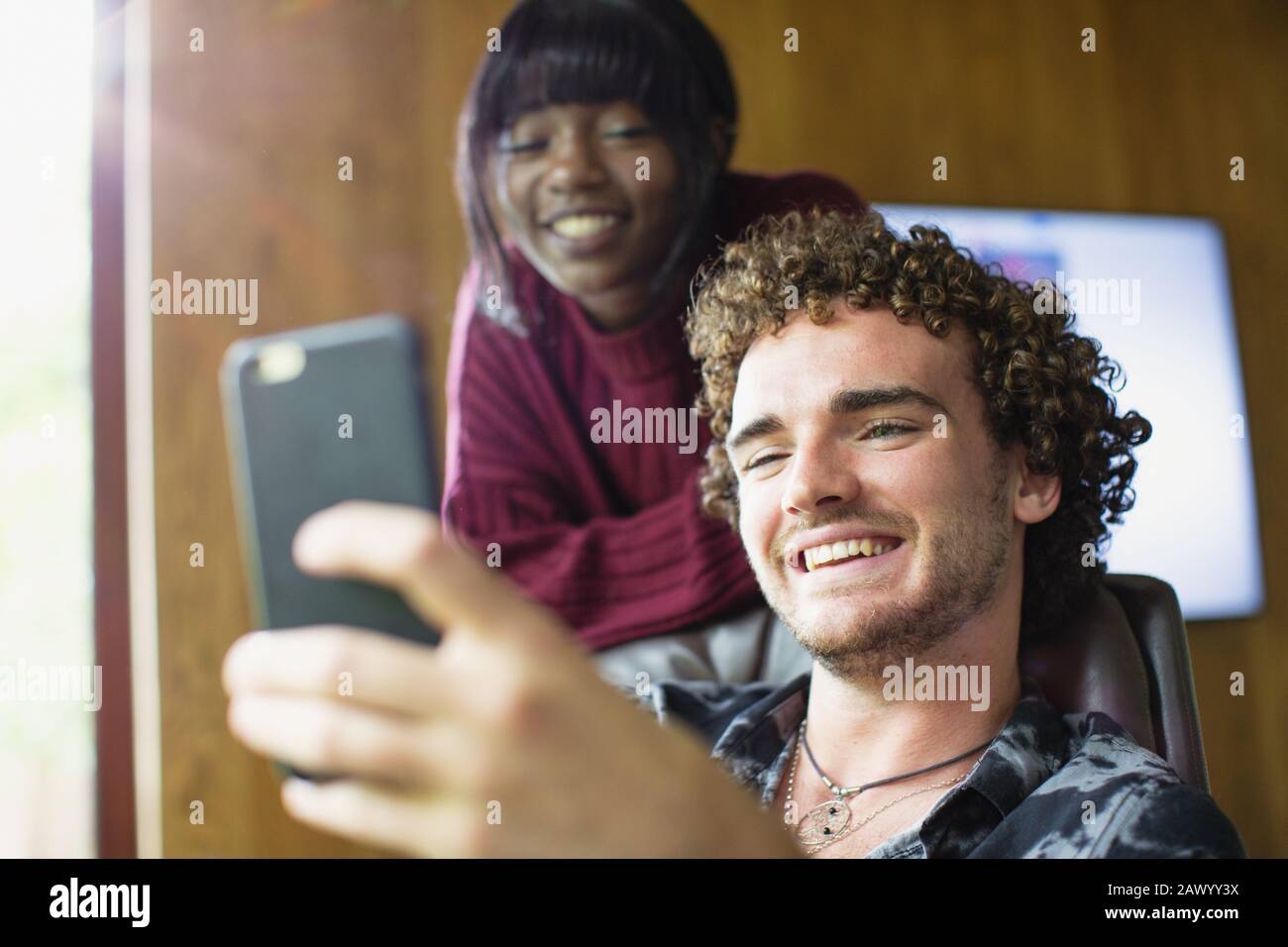 Happy young multiethnic couple video chatting with smart phone Stock Photo