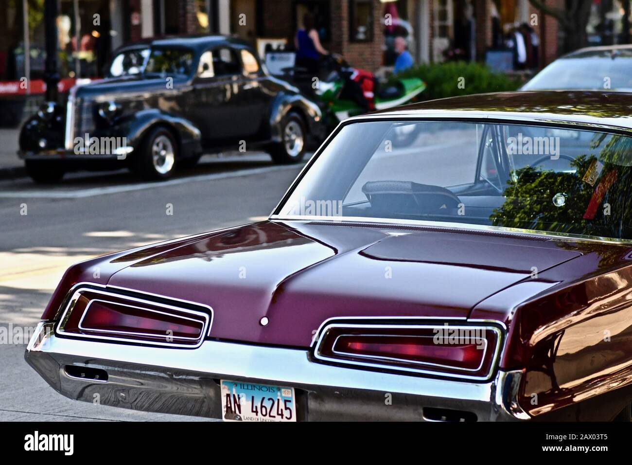 DOWNERS GROVE, UNITED STATES - Jun 07, 2019: A selective focus shot of a shiny maroon vintage car Stock Photo
