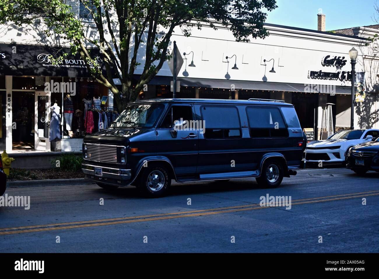 DOWNERS GROVE, UNITED STATES - Jun 07, 2019: A black compact van in a busy road Stock Photo
