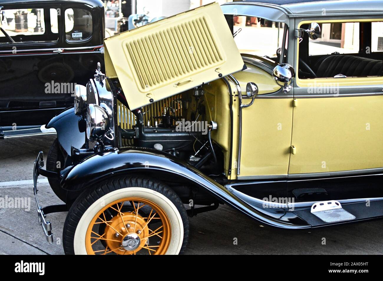 DOWNERS GROVE, UNITED STATES - Jun 07, 2019: A yellow vintage car parked in a parking lot Stock Photo