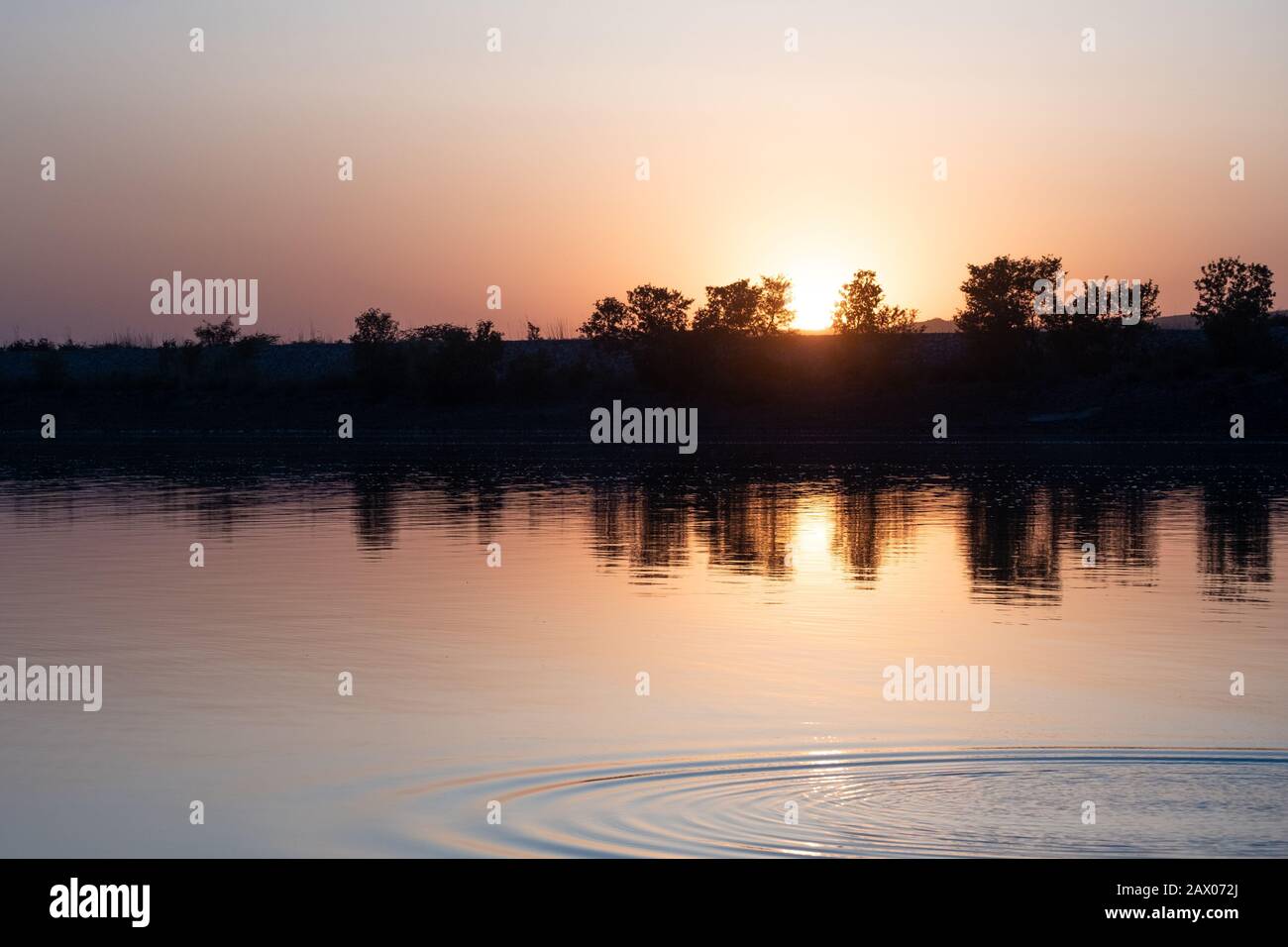 With the reflection of the sun in the clear water Stock Photo - Alamy