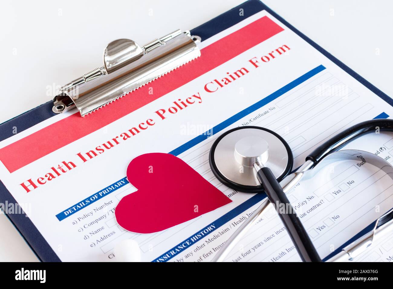 Blank health insurance policy claim form with stethoscope on clipboard