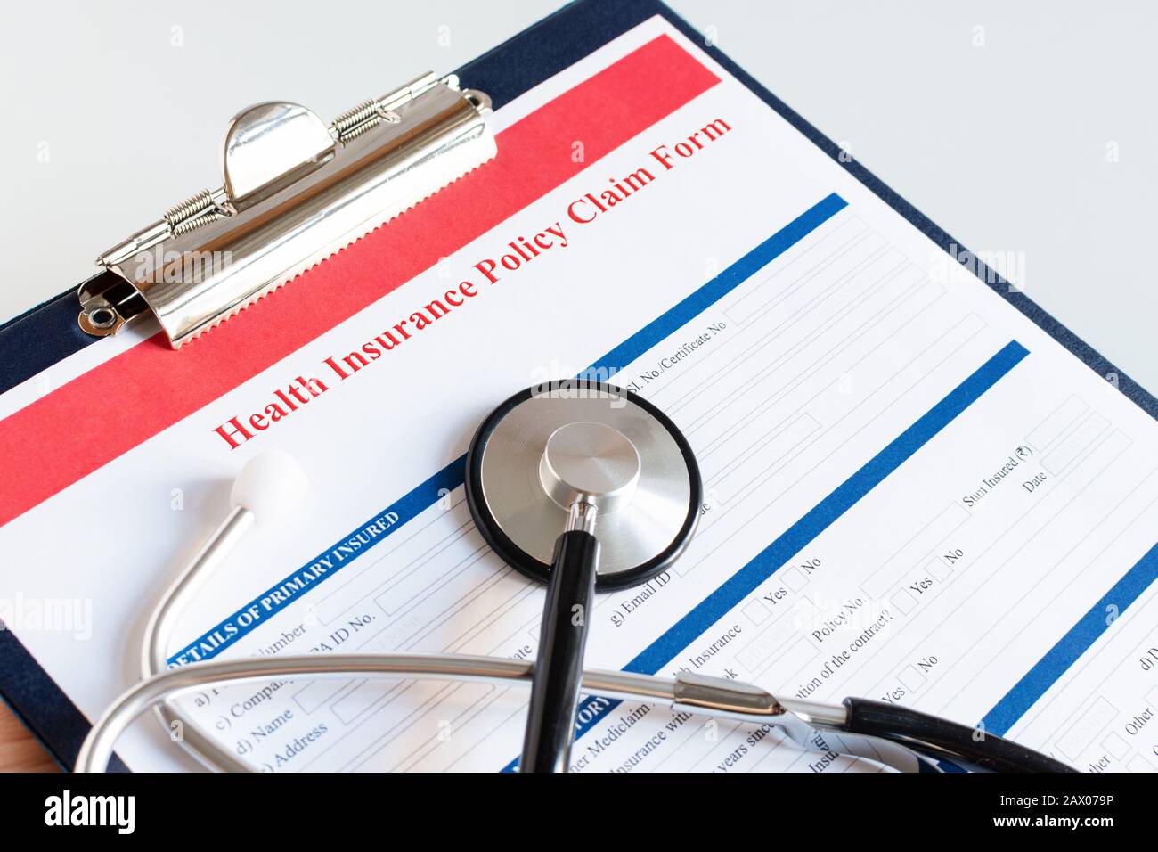 Blank health insurance policy claim form with stethoscope on clipboard