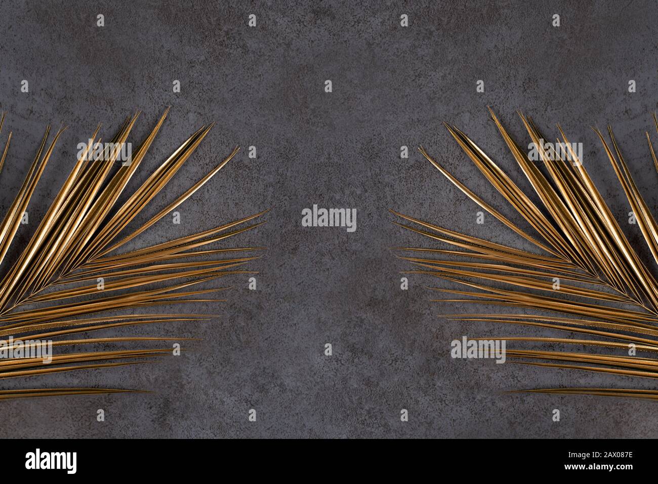Closeup of golden palm leaves on abstract dark grey textured background ...