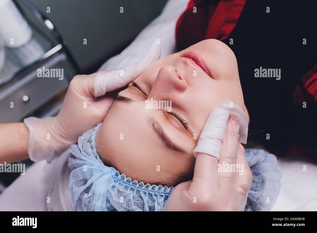 The doctor cosmetologist makes the biorepil facial injections procedure ...