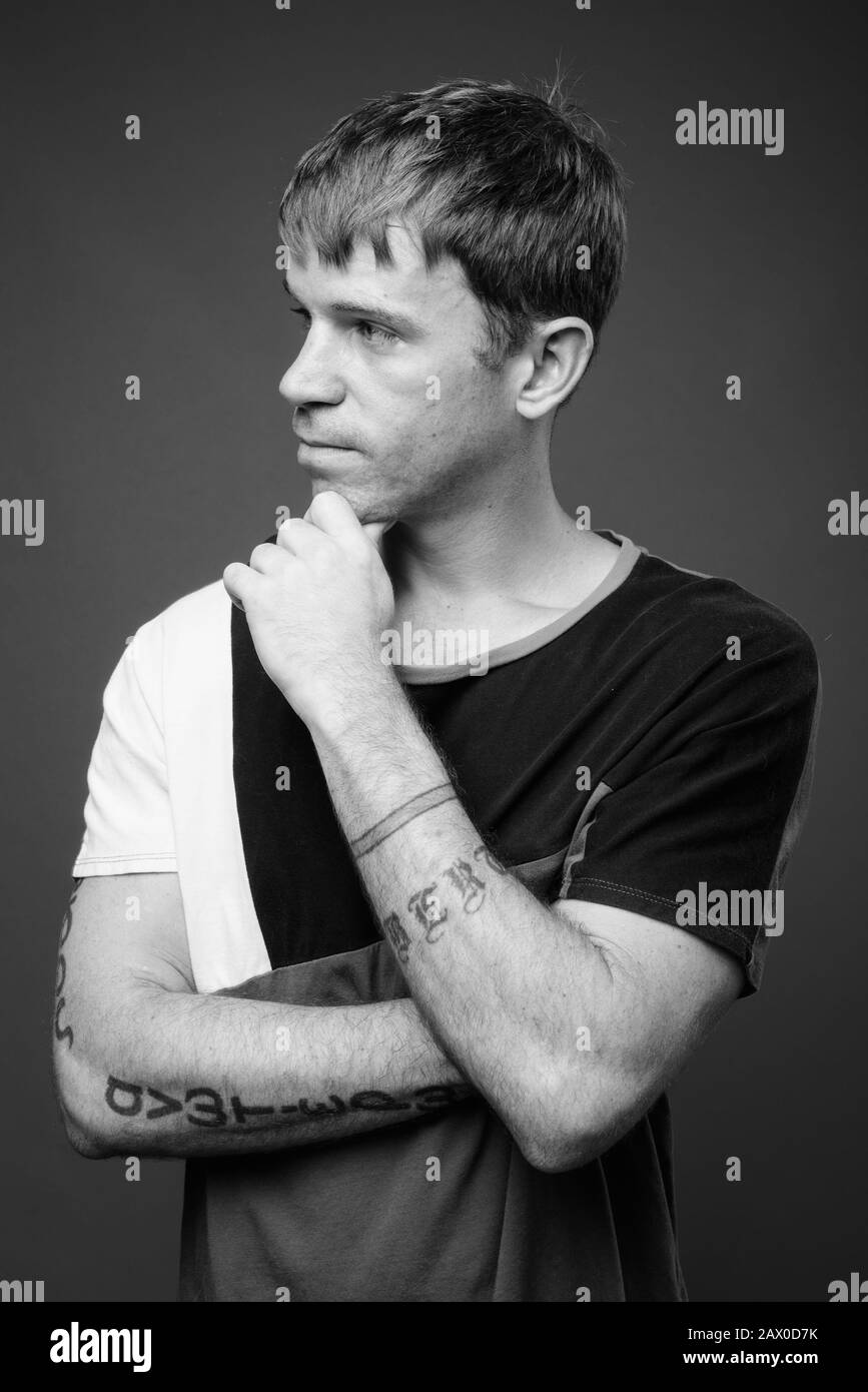 Portrait of man against gray background in black and white Stock Photo