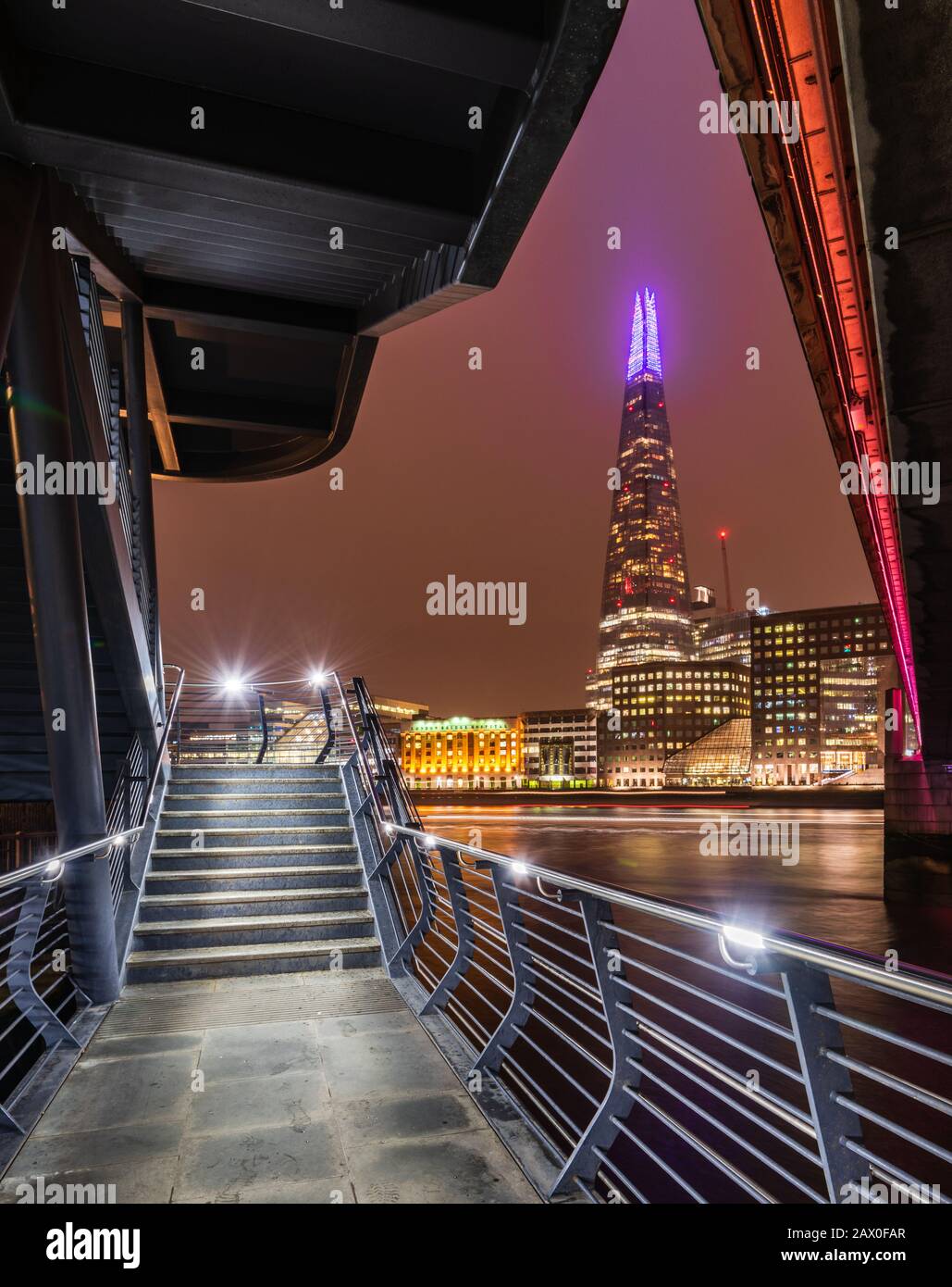 The Shard in London at night taken from beneath London Bridge Stock Photo