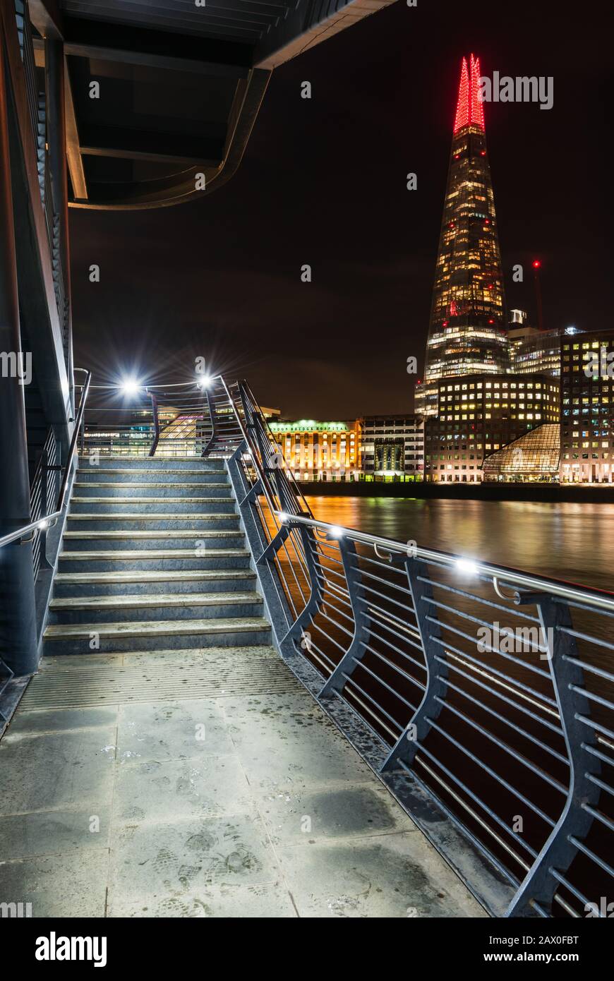 The Shard in London at night taken from beneath London Bridge Stock Photo