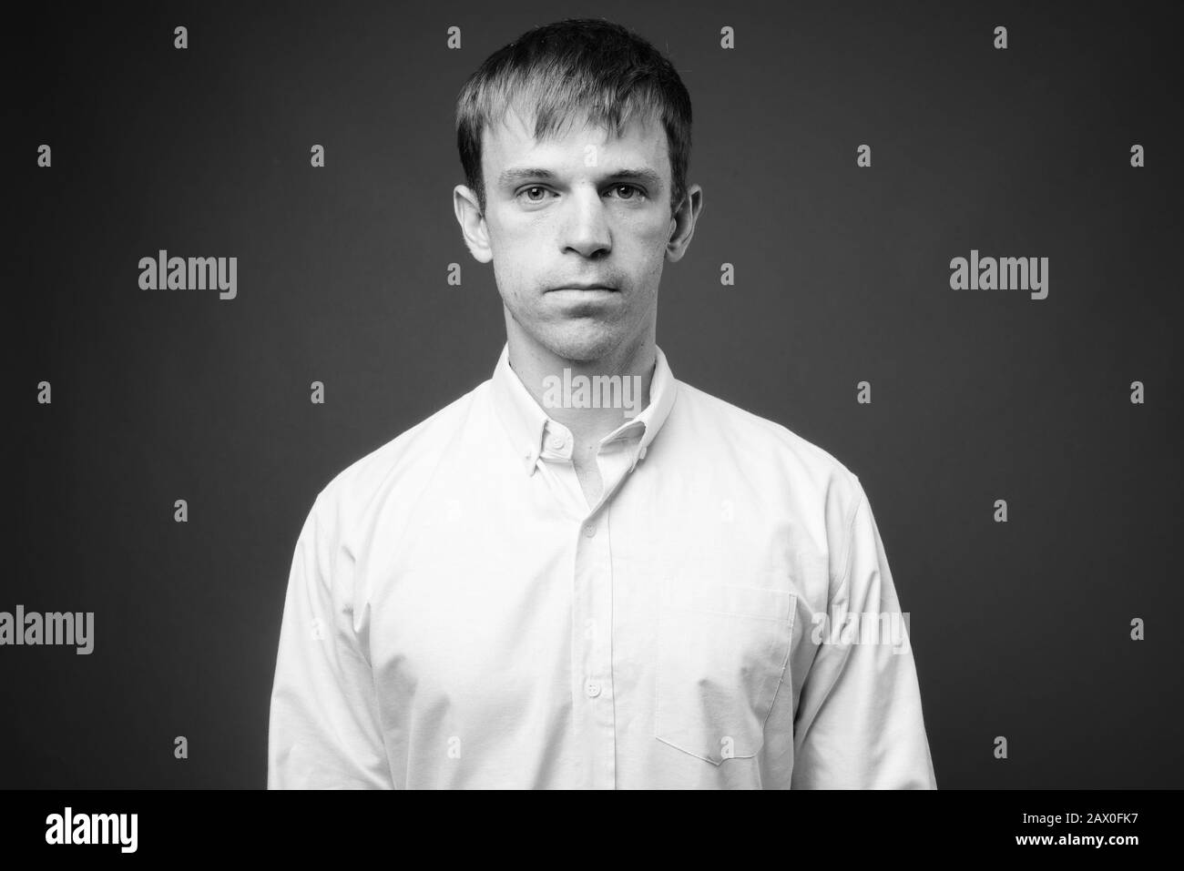 Portrait of businessman against gray background Stock Photo - Alamy