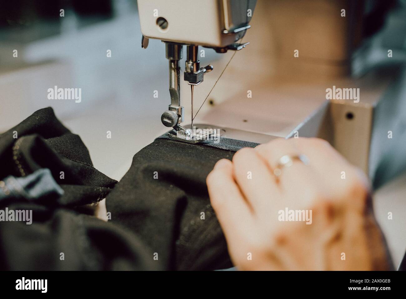 woman sews on the sewing machine Stock Photo Alamy