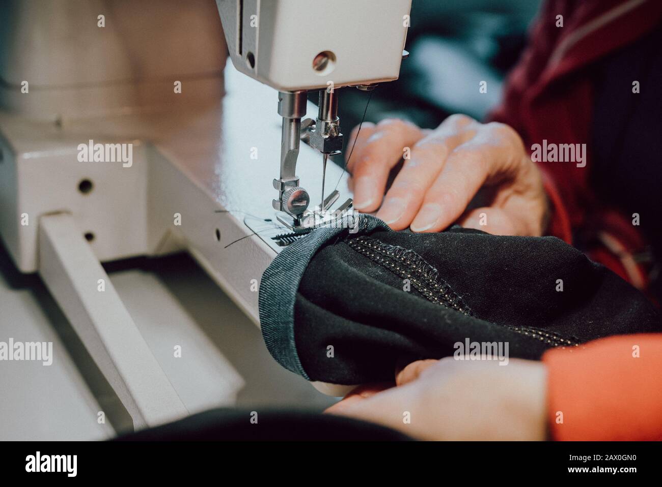 woman sews on the sewing machine Stock Photo Alamy