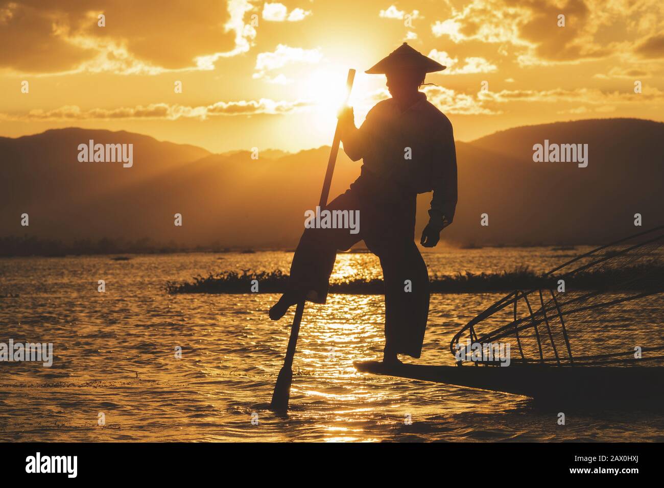 Inle Lake Intha fisherman at sunset in Shan State, Myanmar (Burma). Stock Photo