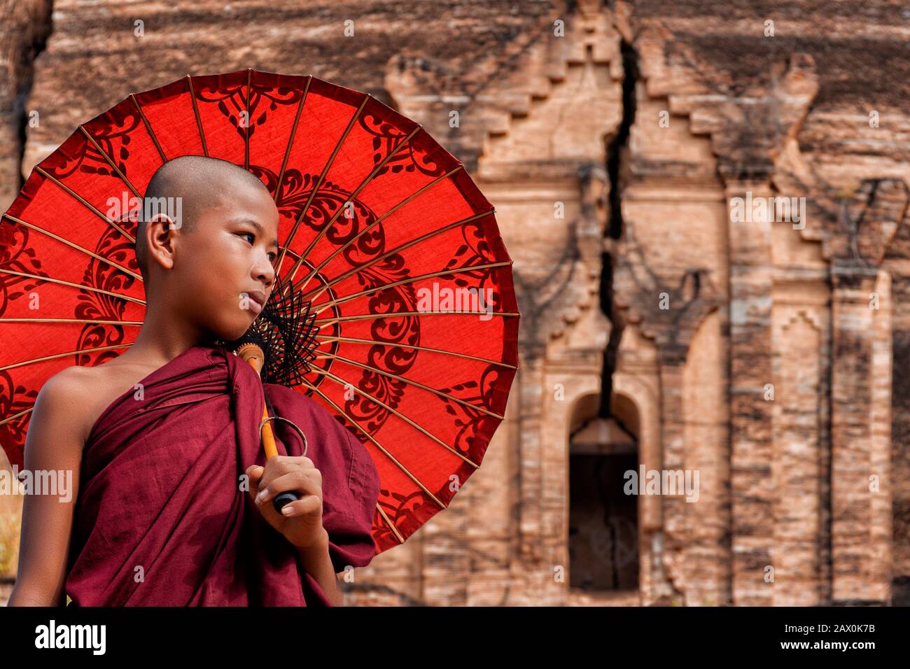 Mandalay, Myanmar (Burma), a novice Buddhist monk at the ruins of the Mingun Pahtodawgyi Pagoda. Stock Photo