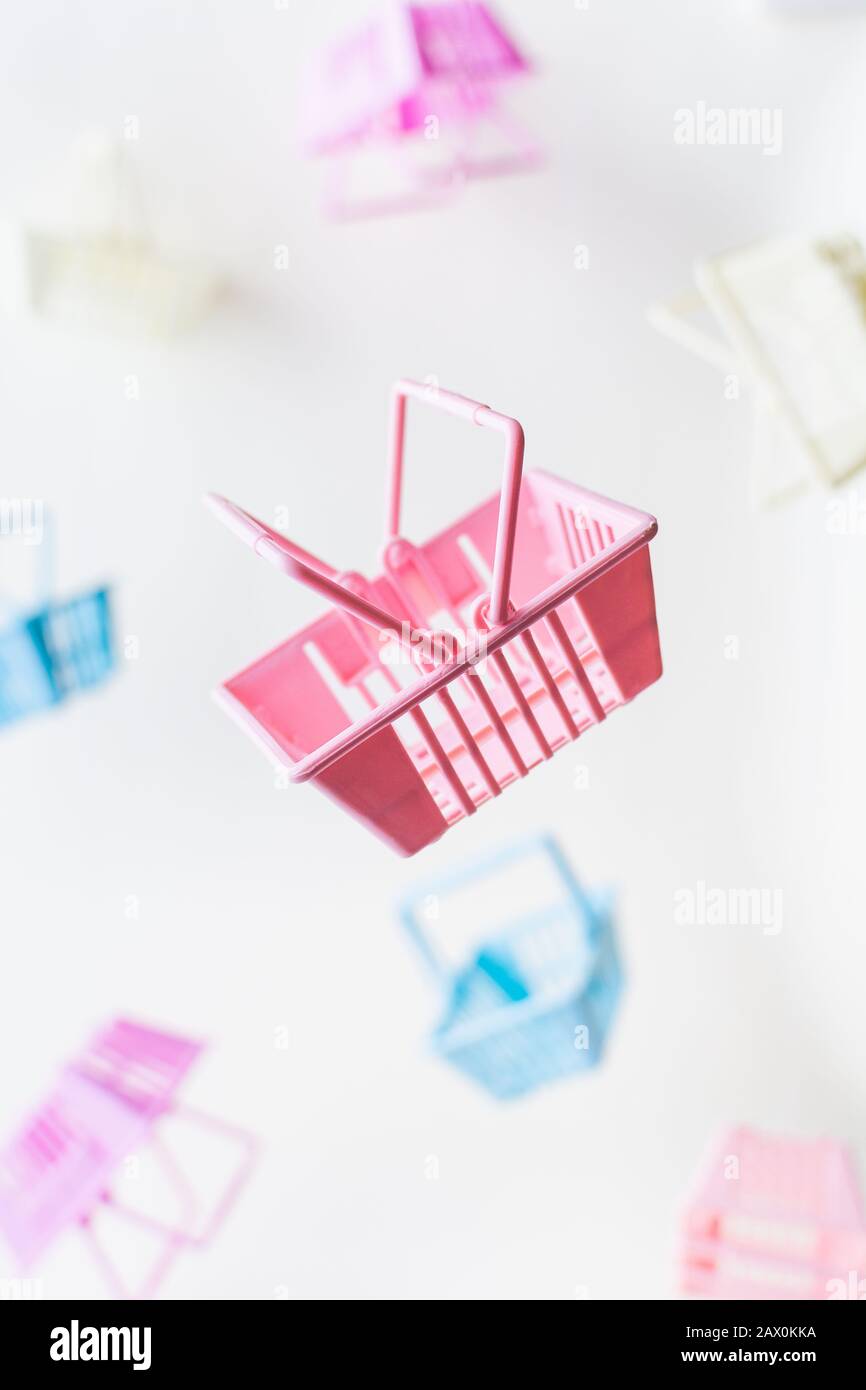 Levitating retail shopping baskets on white background. Vertical orientation Stock Photo