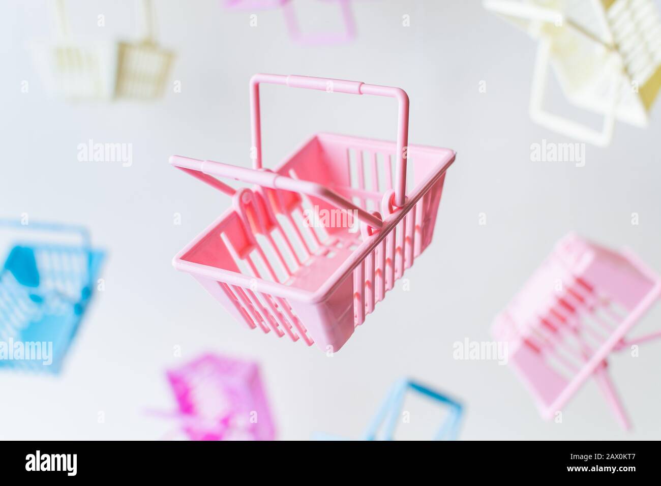 Levitating empty plastic shopping baskets on white background. Stock Photo