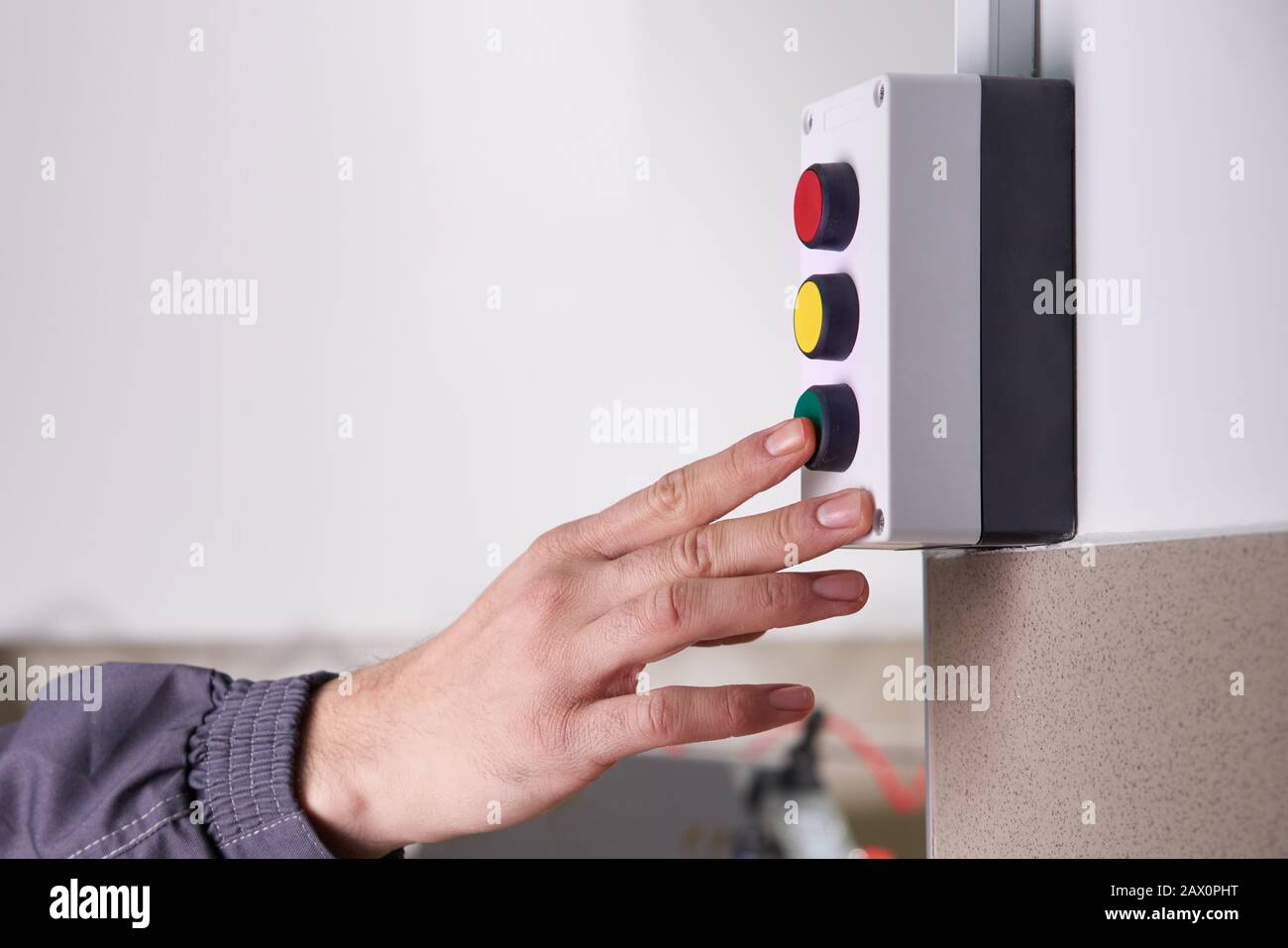 Worker operating a machine in a factory Stock Photo