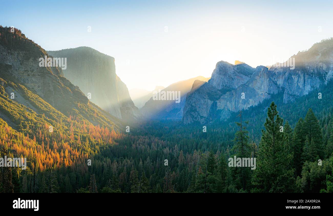 Beautiful panoramic sunrise scene of famous Tunnel View in scenic Yosemite Valley with majestic El Capitan and Half Dome rock, California, USA Stock Photo