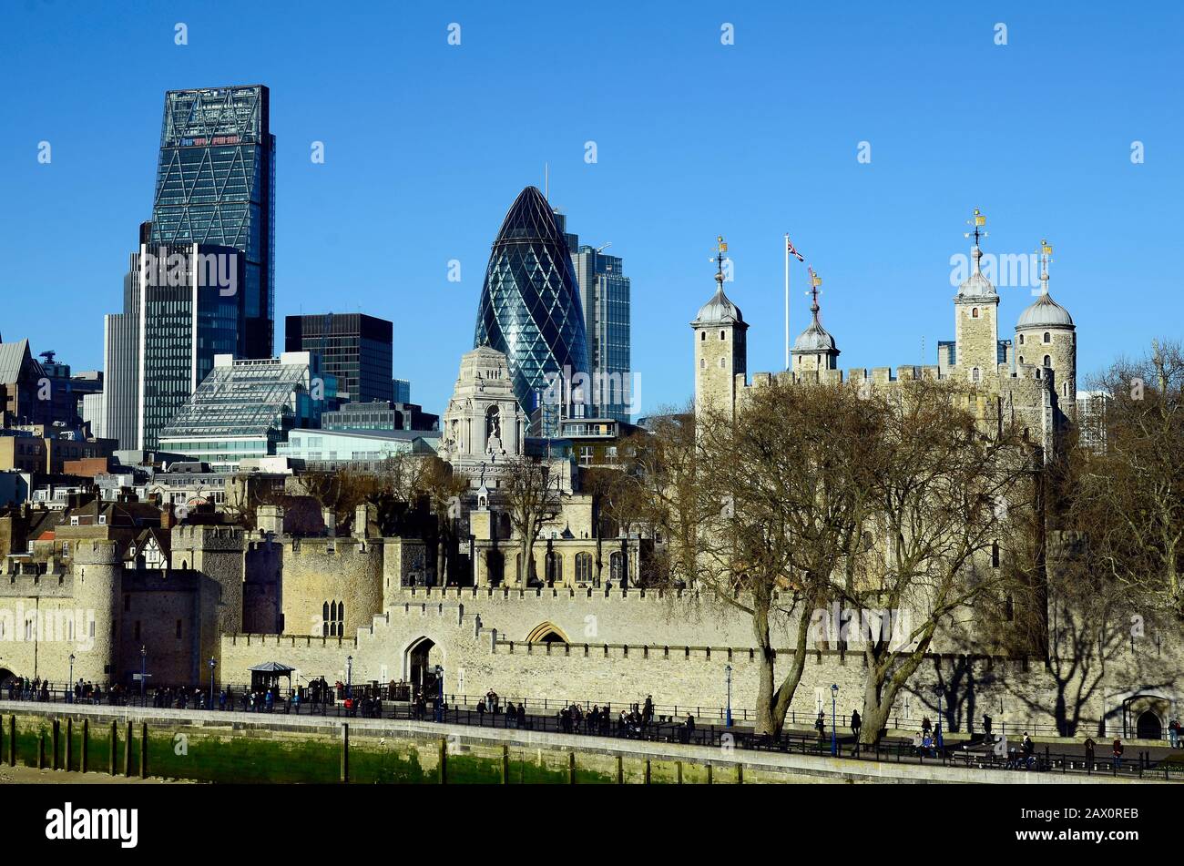 London, United Kingdom - January 15th 2016: Unidentified people and Tower of London with The Gherkin and Leadenhall building aka Cheese Grater behind Stock Photo