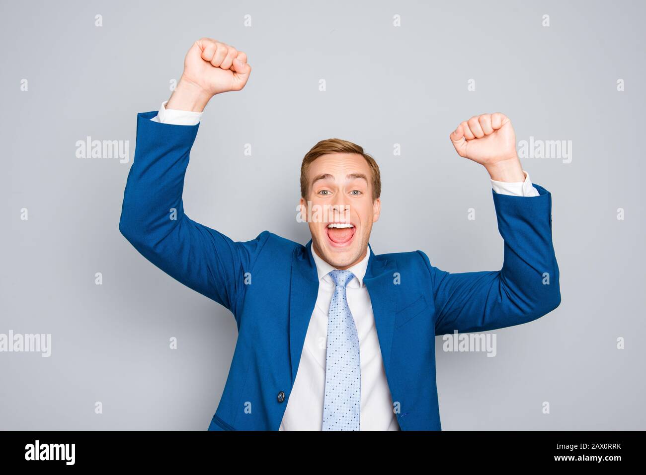 Portrait of happy businessman celebrating victory with raised hands ...