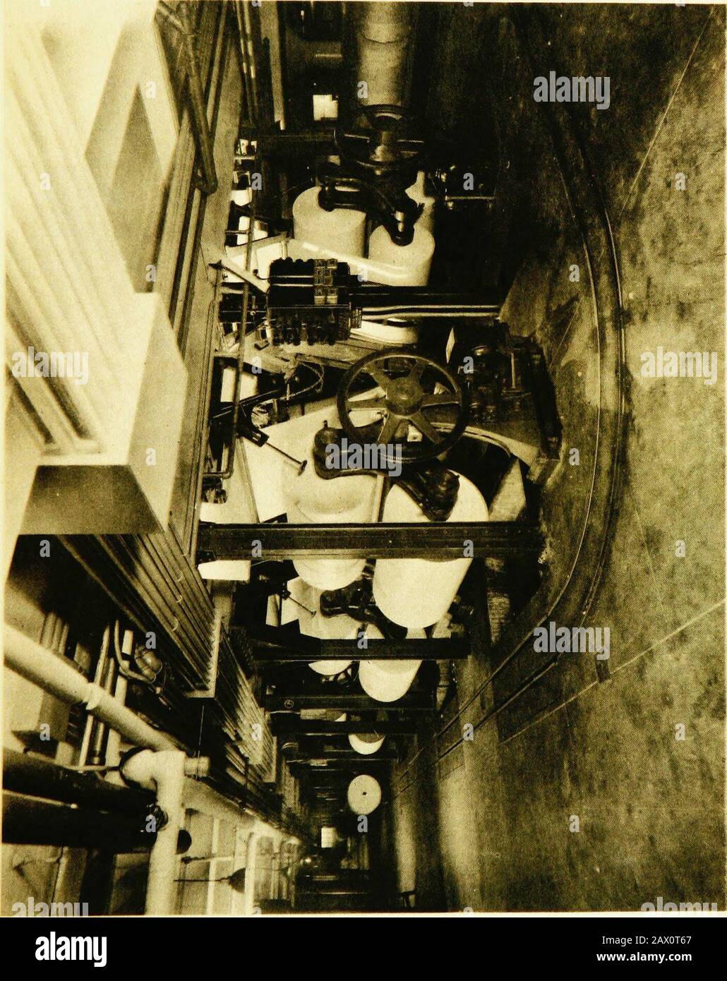 The Detroit news: eighteen hundred and seventy-three, nineteen hundred and seventeen, a record of progress: . t rate of consumption. Warehouses elsewhere in the city contain thevast supplies which safeguard The News meantime, and these are tapped tokeep the storage pier in the basement filled. The loading of the pier is the first step in the efficient circular movement ofthe bulky raw material of the newspaper. The paper arrives on trucks, in theshipping room, and is lifted by electric hoists and dropped into a paper tunnelthrough which it rolls, on an elevated runway, to scales. After being w Stock Photo