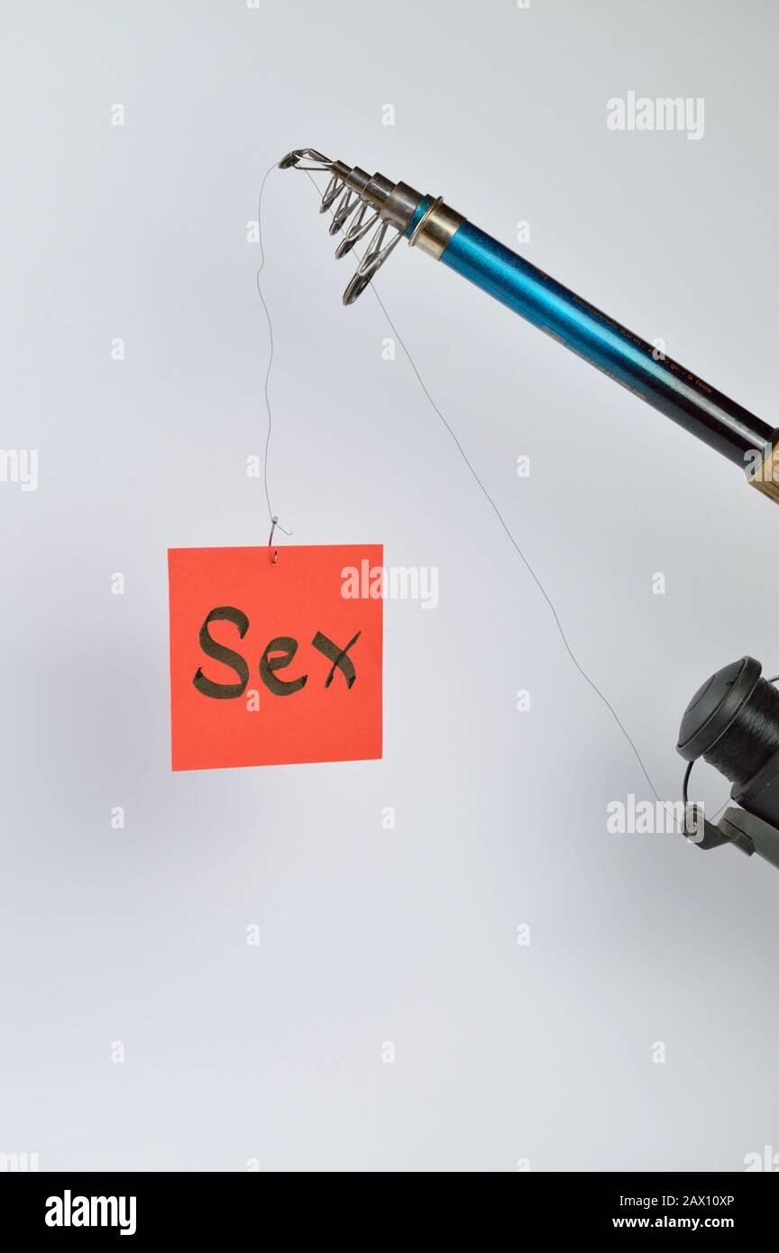 fishing line with piece of paper on it as symbol for temptation Stock Photo