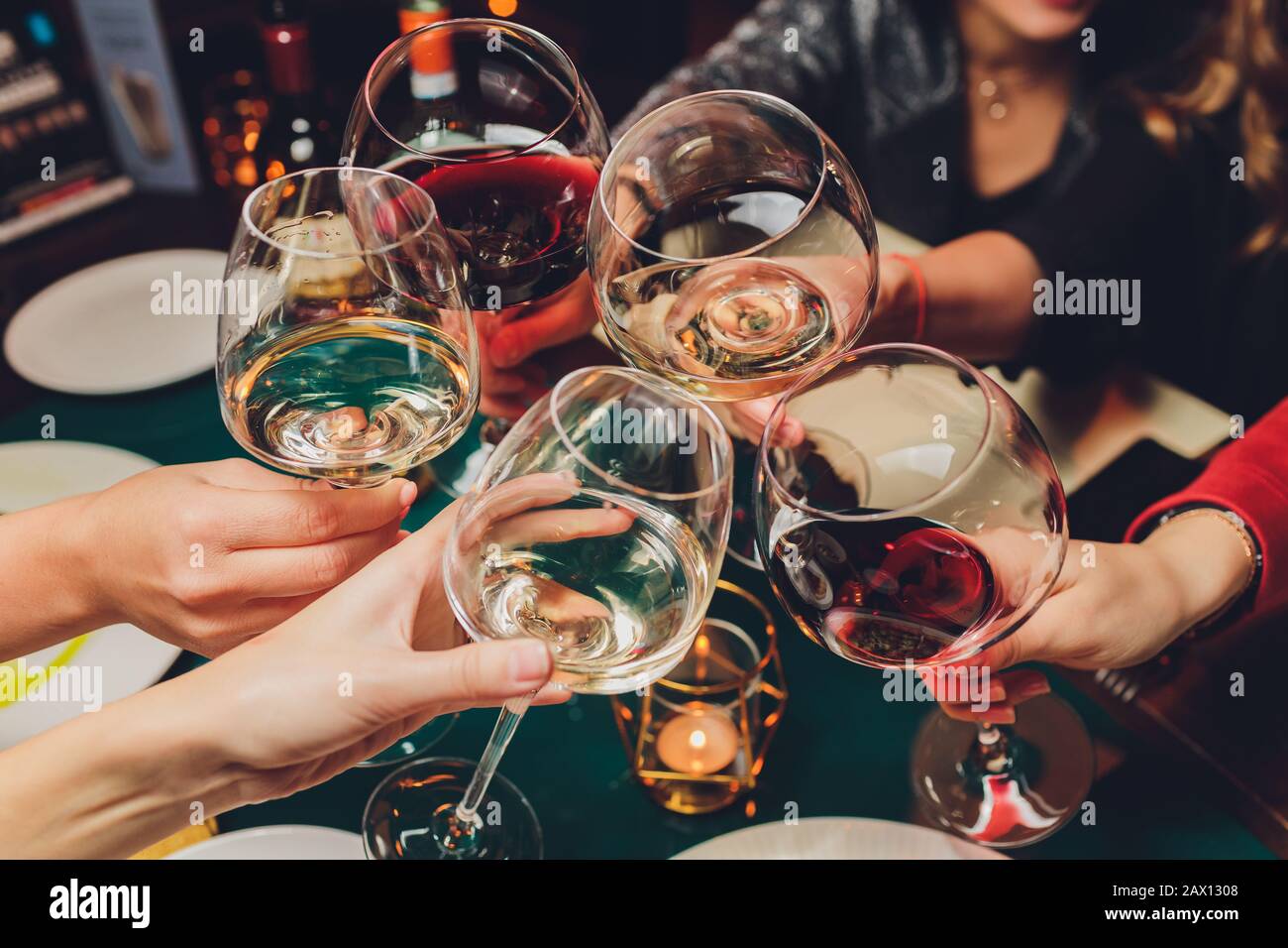 Clinking glasses with alcohol and toasting, party Stock Photo Alamy