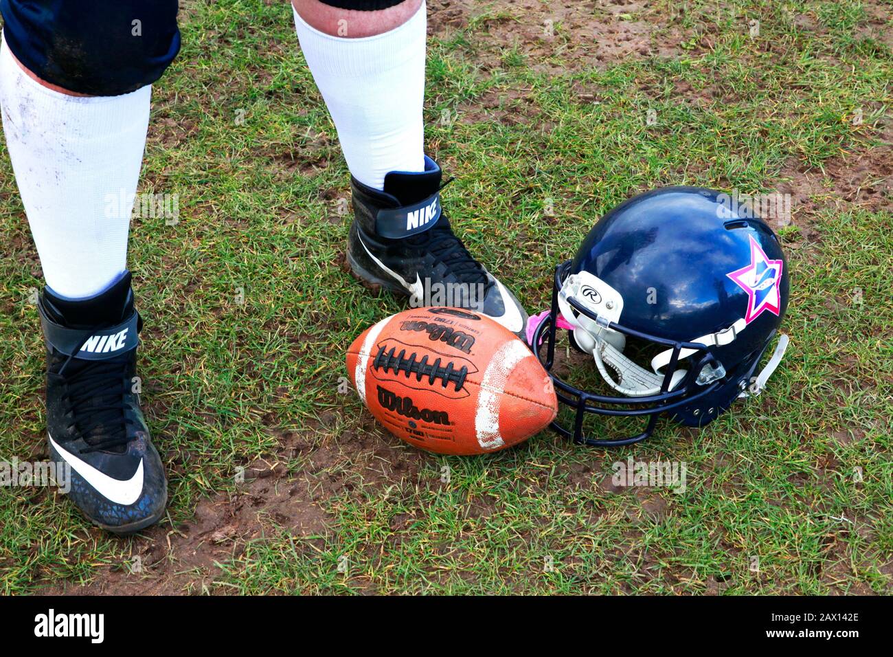 American football player with helmet and ball Stock Photo