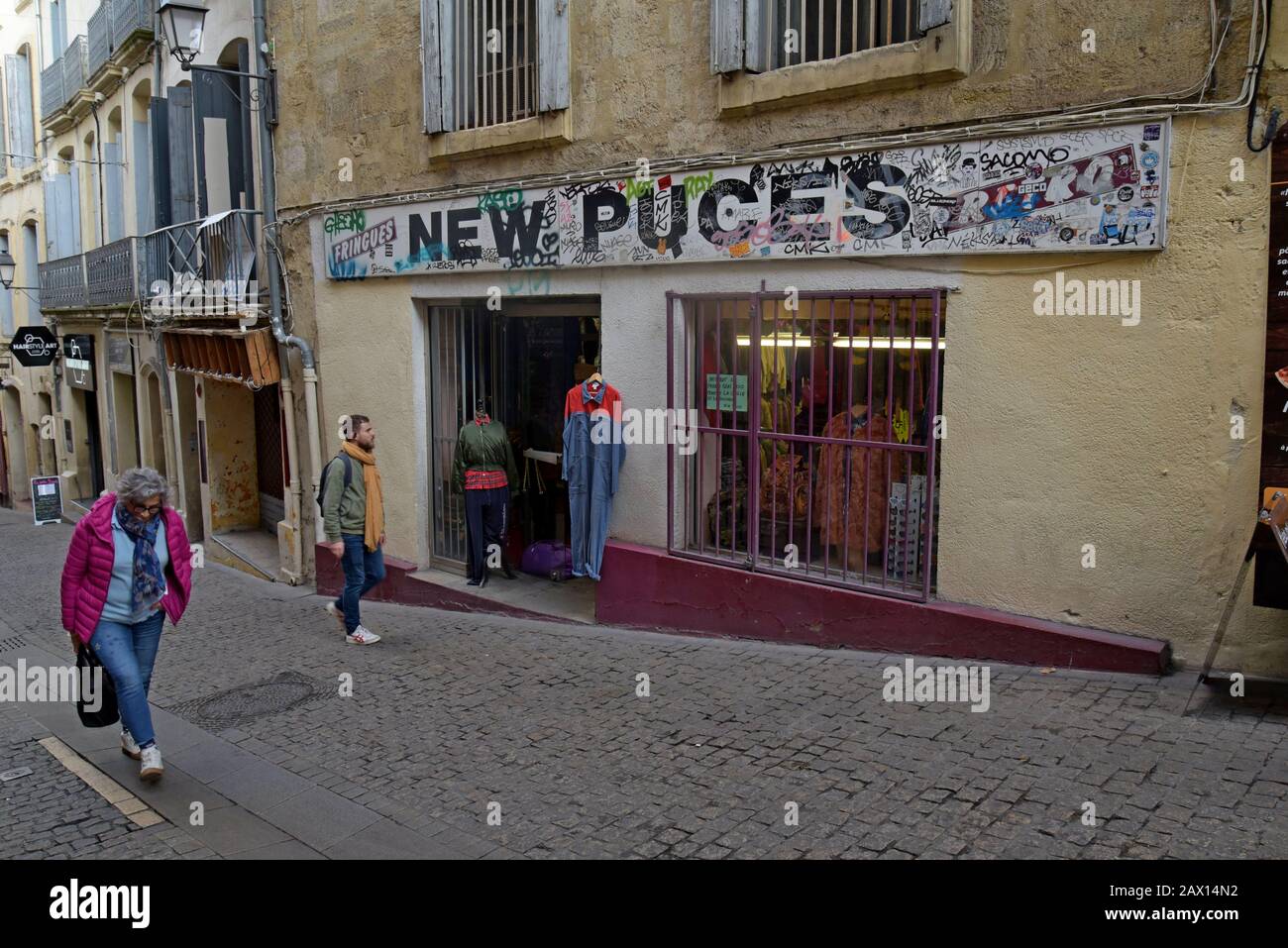 People walking past vintage clothing shops in Rue de l'Université, Montpellier, France Stock Photo