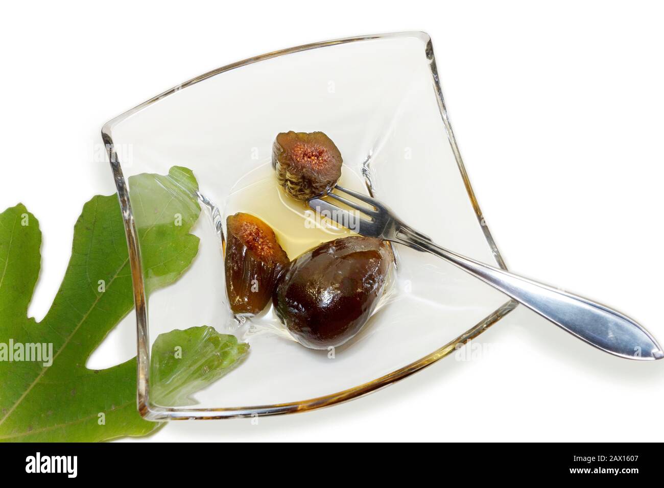 Unripe fig Spoon Sweet (Sikalaki Gliko) Baby fig spoon sweet (Sikalaki Gliko) served in a glass saucer. Stock Photo