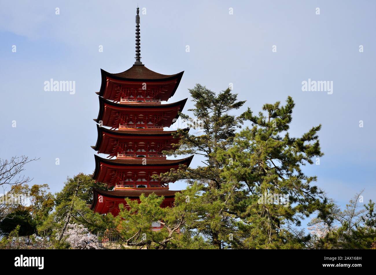 The tall structure of the temple stands out on the trees rising in the sky Stock Photo