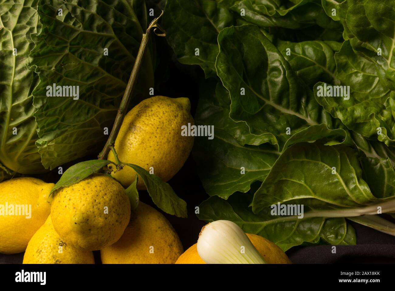 Lemon citrus fruit with an acidic taste and freshly picked vegetables