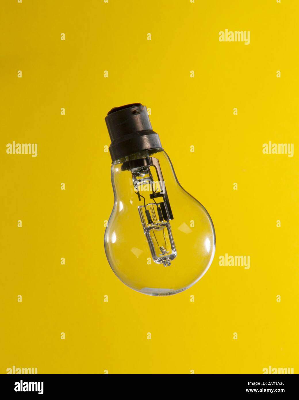 Clean Lightbulb on Yellow Background Stock Photo