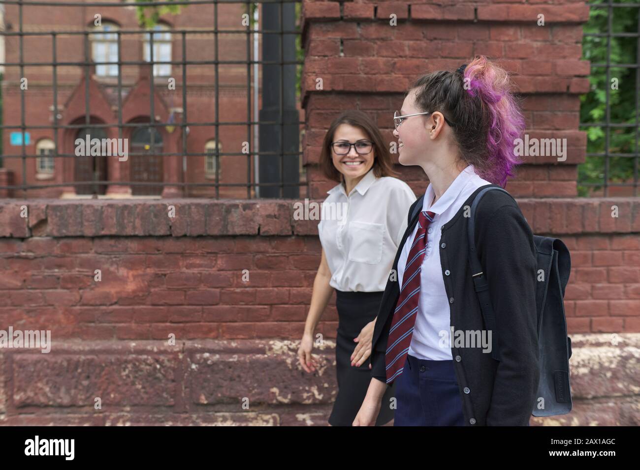 Girl student teenager walking and talking with woman teacher Stock ...