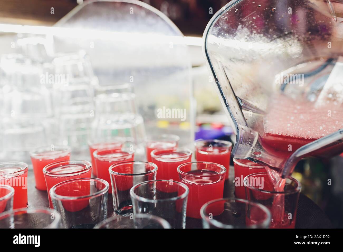 Several red alcohol shots on a bar Stock Photo