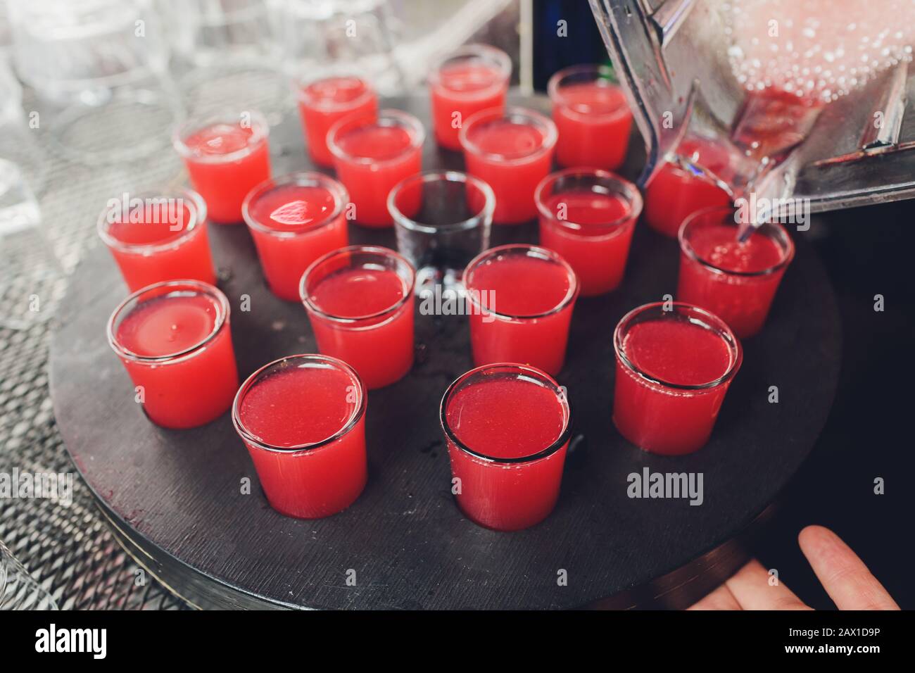 Several red alcohol shots on a bar Stock Photo