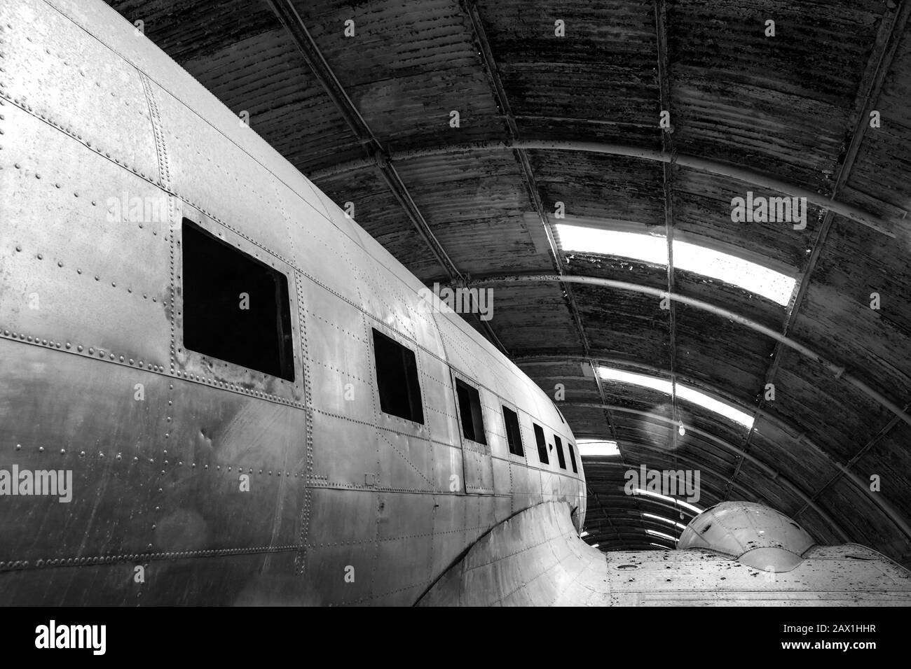 Abstract detail monochrome shot of a disused old aircraft in a hangar Stock Photo