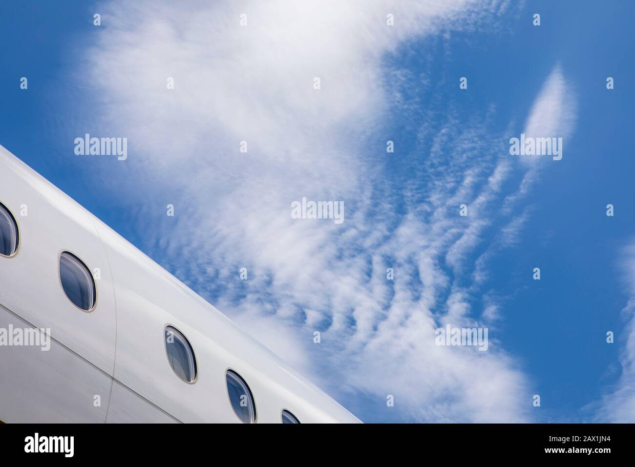 Airplane fuselage mid plane with blue skies Stock Photo