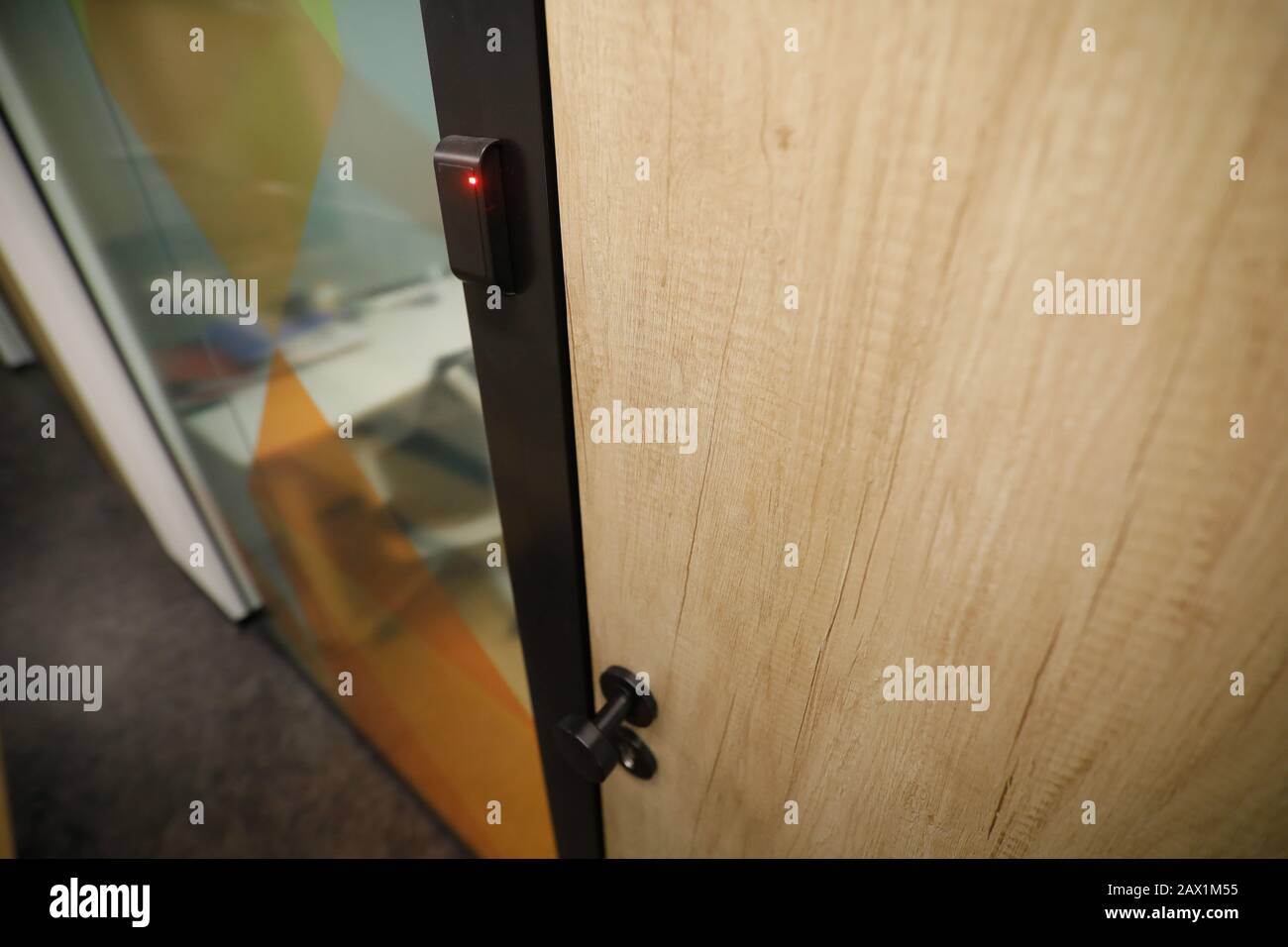 Shallow depth of field (selective focus) image with the locked wooden door inside an office building. Stock Photo