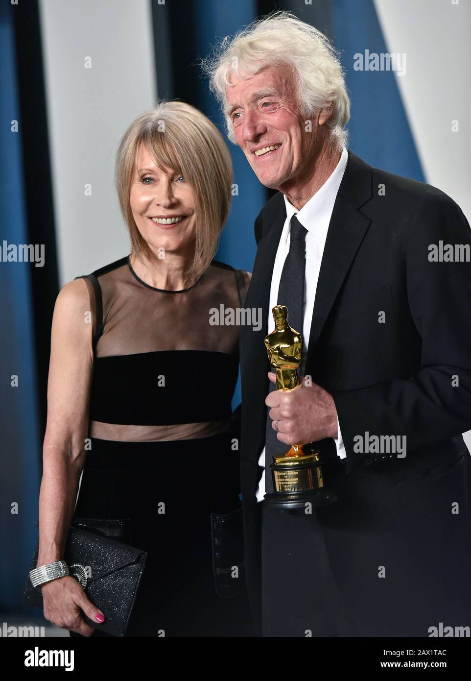 Beverly Hills, United States. 10th Feb, 2020. Roger Deakins (R) holds his Oscar for Best Cinematography as he and his wife Isabella James Purefoy Ellis arrive for the Vanity Fair Oscar party at the Wallis Annenberg Center for the Performing Arts in Beverly Hills, California on February 9, 2020. Photo by Chris Chew/UPI Credit: UPI/Alamy Live News Stock Photo