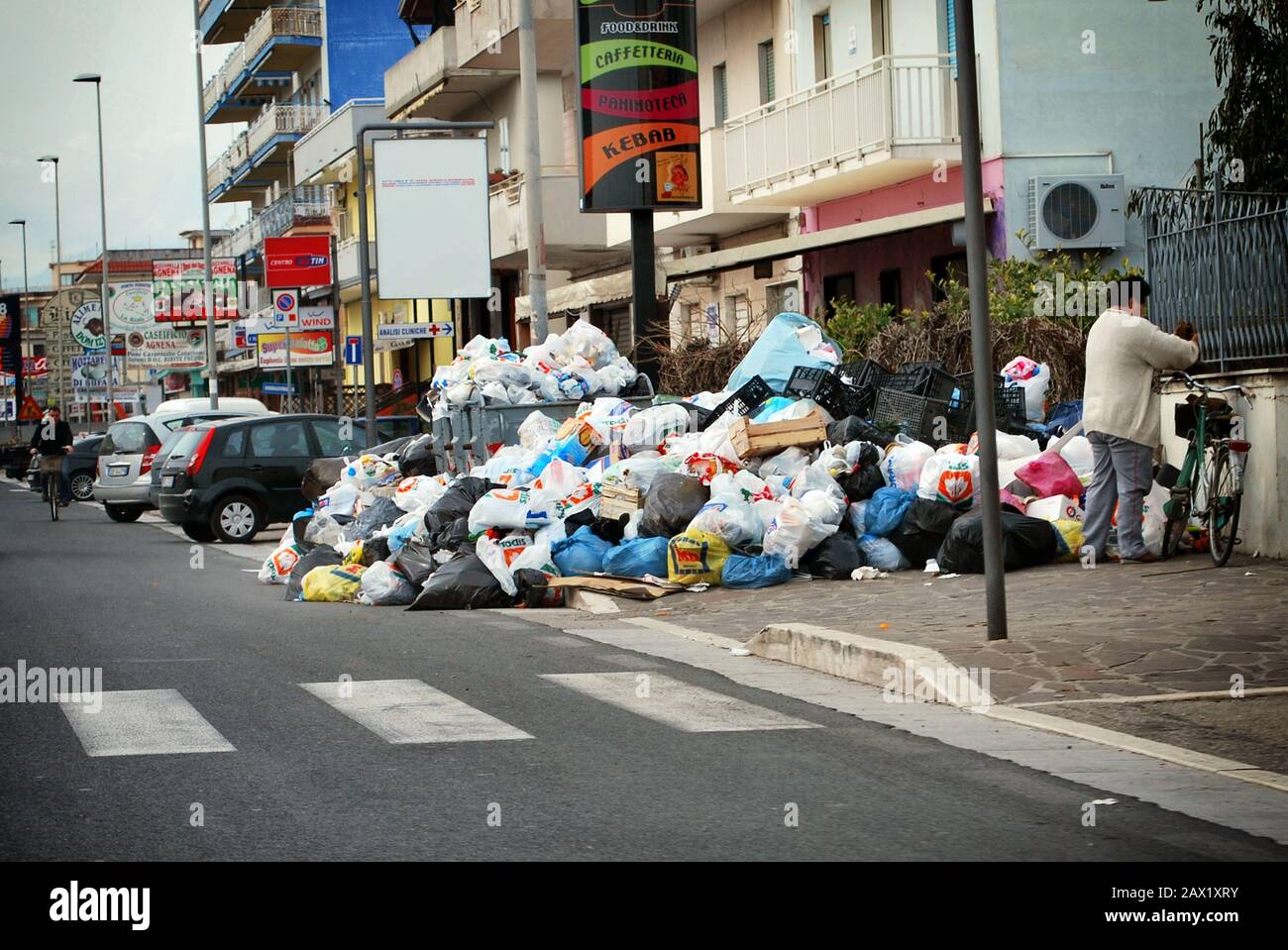 Mondragone, Italy - March 24, 2010: Waste emergency, garbage on the ground near the bins Stock Photo